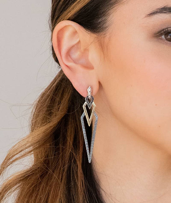 Close up photo of model wearing triangular earrings