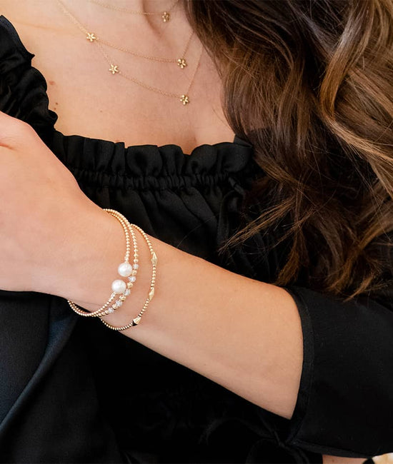 Close up photo of model wearing bracelets on wrist