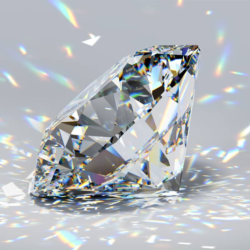 Close up photo of a diamond with light shining through it.