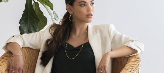Photo of model wearing multiple pieces of fine jewelry