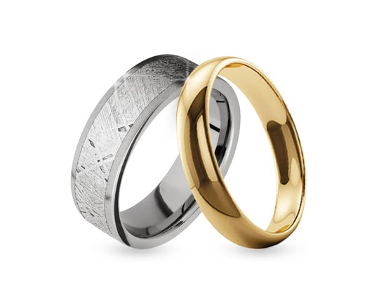 Photo of 2 men's wedding bands leaning against each other
